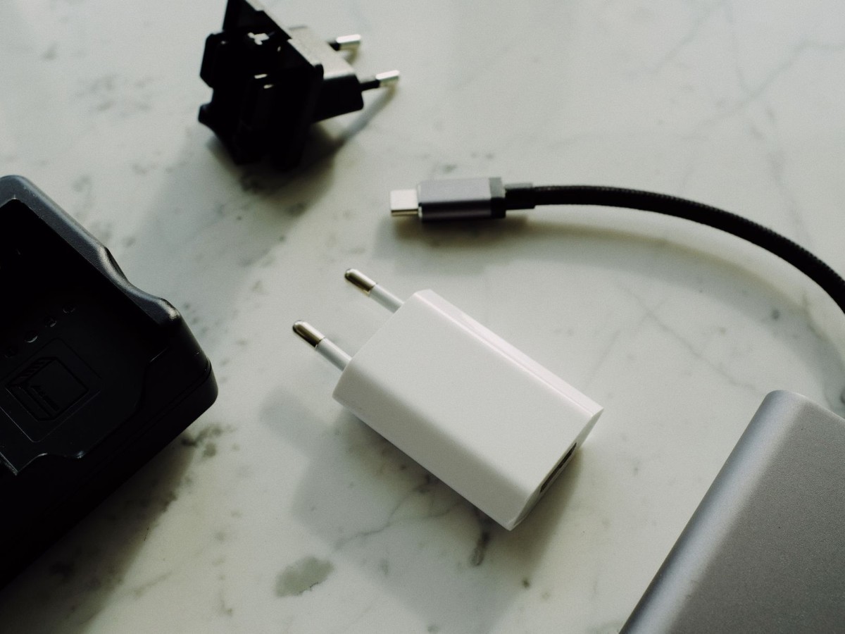 Chargers and USB cables laid out on a surface Chargers and USB cables laid out on a surface