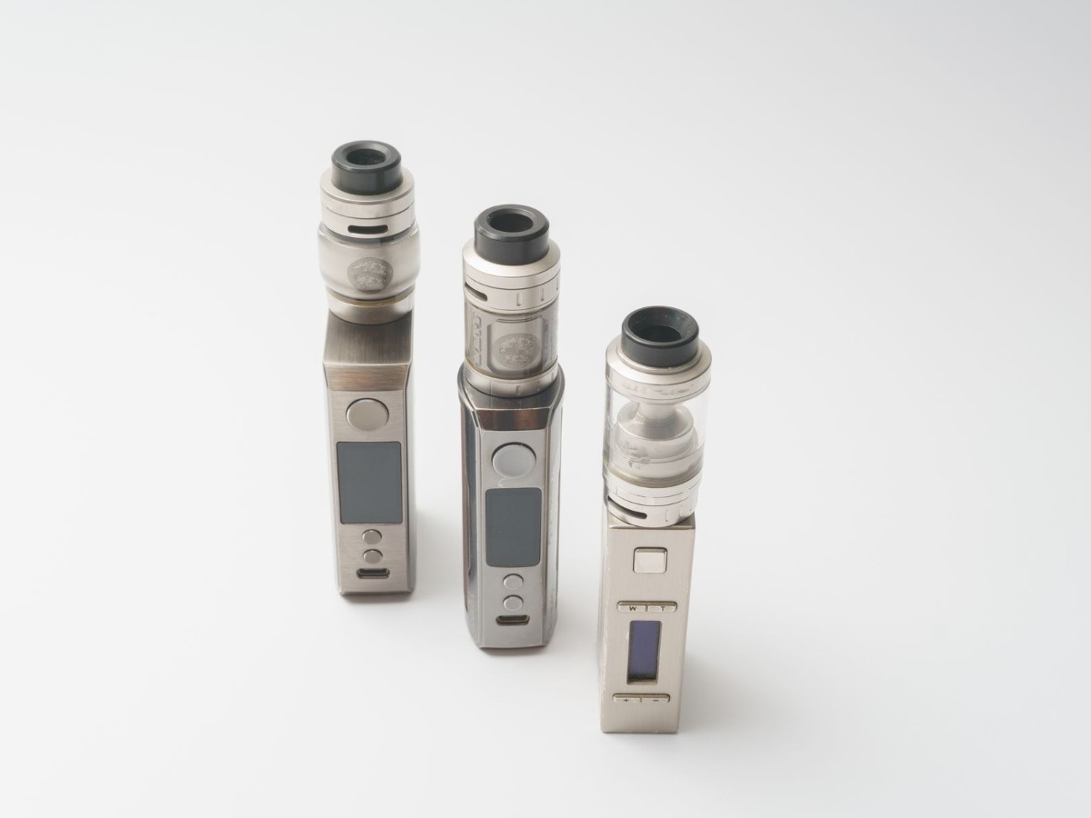 Three vape devices on a clean white background